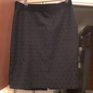 Black skirt with back slit.